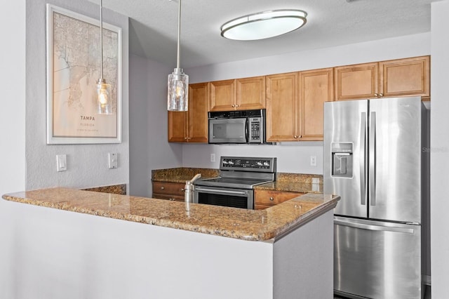 kitchen featuring a peninsula, brown cabinetry, appliances with stainless steel finishes, and stone countertops