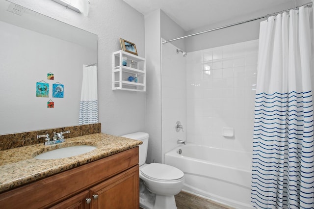 bathroom with toilet, shower / bath combo with shower curtain, and vanity
