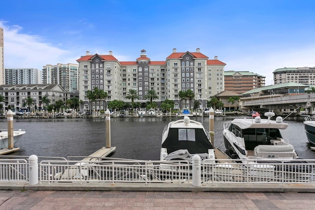 dock area with a water view and fence