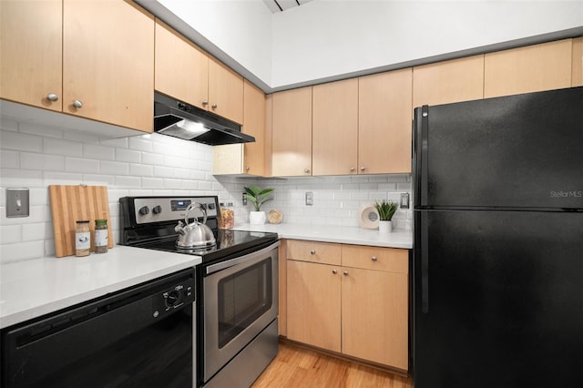 2410 W Azeele St Unit 228, Tampa, FL 33609 - kitchen featuring black appliances, under cabinet range hood, light countertops, and light wood-style floors