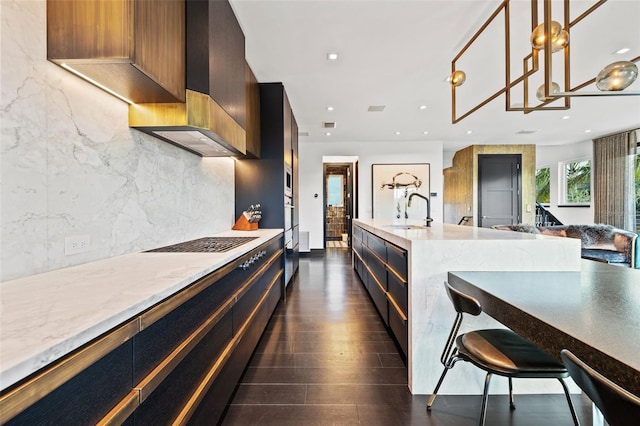 325 2nd St N, Saint Petersburg, FL 33701 - kitchen featuring a sink, decorative backsplash, open floor plan, modern cabinets, and pendant lighting