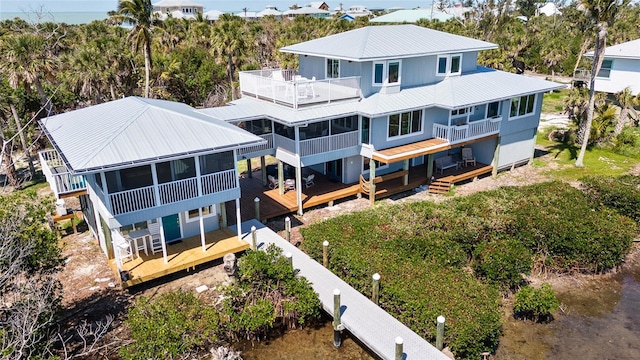 9048 Wharf Ave, Placida, FL 33946 - rear view of property with a sunroom, metal roof, a deck, and a balcony