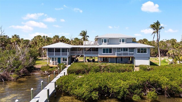 9048 Wharf Ave, Placida, FL 33946 - rear view of house with a water view, metal roof, and a sunroom