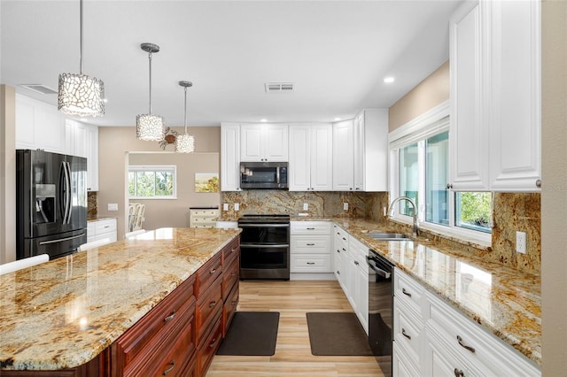 9048 Wharf Ave, Placida, FL 33946 - kitchen with light wood-style flooring, white cabinets, visible vents, appliances with stainless steel finishes, and a sink