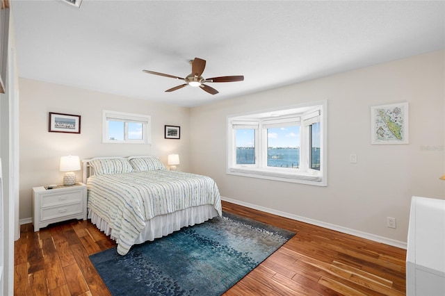 9048 Wharf Ave, Placida, FL 33946 - bedroom with a ceiling fan, baseboards, and dark wood finished floors