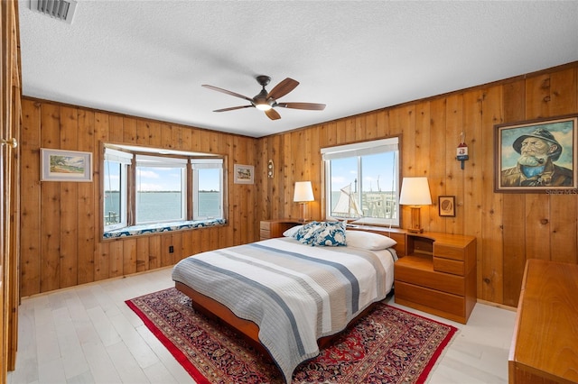 9048 Wharf Ave, Placida, FL 33946 - bedroom with wooden walls, visible vents, and multiple windows
