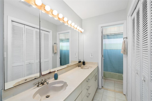 9048 Wharf Ave, Placida, FL 33946 - bathroom featuring a closet, double vanity, tile patterned floors, visible vents, and a sink