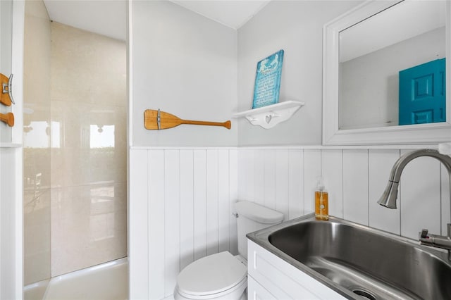 9048 Wharf Ave, Placida, FL 33946 - full bathroom featuring vanity, toilet, wainscoting, a shower, and a tub to relax in
