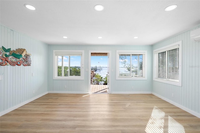 9048 Wharf Ave, Placida, FL 33946 - unfurnished living room with plenty of natural light, light wood-style floors, and baseboards