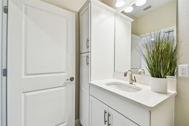 bathroom with visible vents and vanity