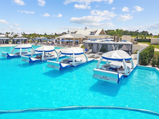 community pool featuring a water play area and a patio area