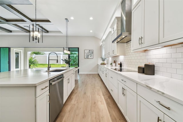 kitchen with stainless steel dishwasher, wall chimney range hood, a sink, a center island with sink, and black electric cooktop