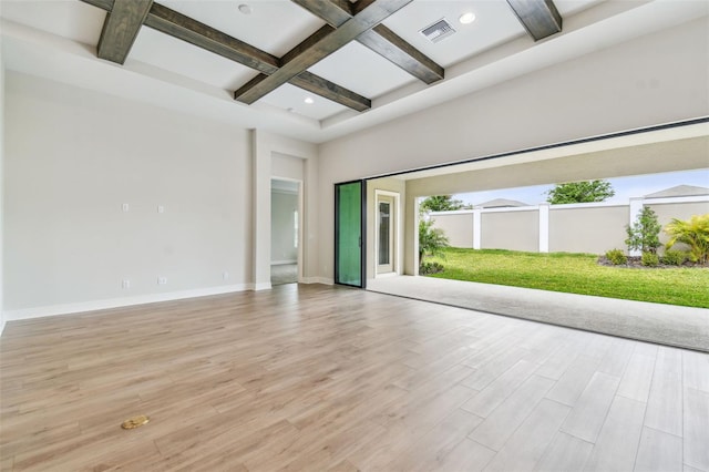 spare room with visible vents, baseboards, light wood-type flooring, beamed ceiling, and coffered ceiling