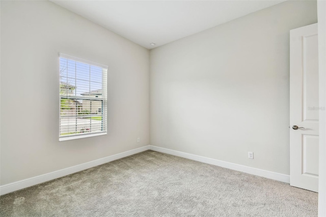 carpeted empty room with baseboards