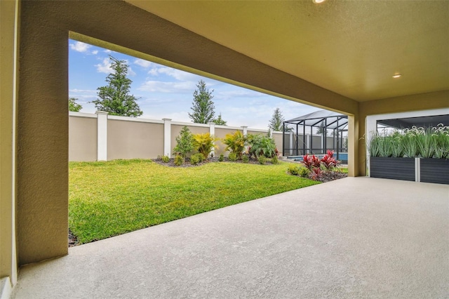 view of patio with glass enclosure