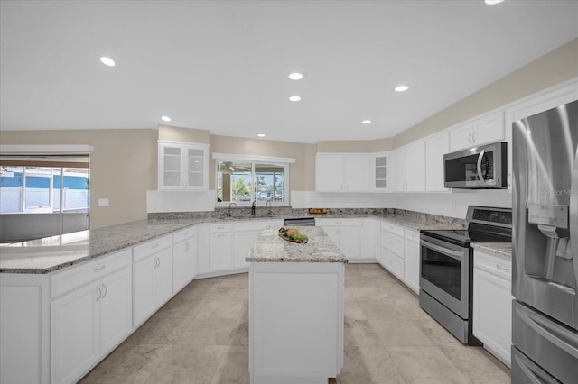 3506 Seaway Dr, New Port Richey, FL 34652 - kitchen with glass insert cabinets, a center island, a sink, appliances with stainless steel finishes, and a peninsula