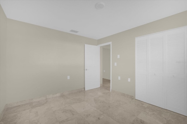 3506 Seaway Dr, New Port Richey, FL 34652 - unfurnished bedroom featuring a closet, marble finish floor, and visible vents