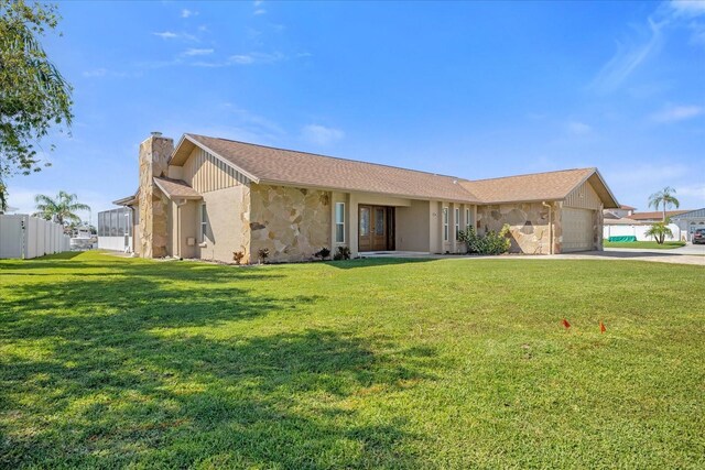 3506 Seaway Dr, New Port Richey, FL 34652 - single story home featuring a garage, a front yard, stone siding, a chimney, and concrete driveway
