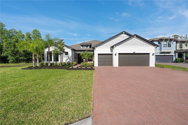 view of front of home with a garage, a front lawn, decorative driveway, and stucco siding
