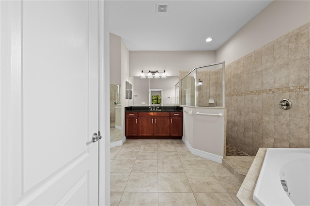 bathroom with vanity, tile patterned floors, visible vents, walk in shower, and a jetted tub