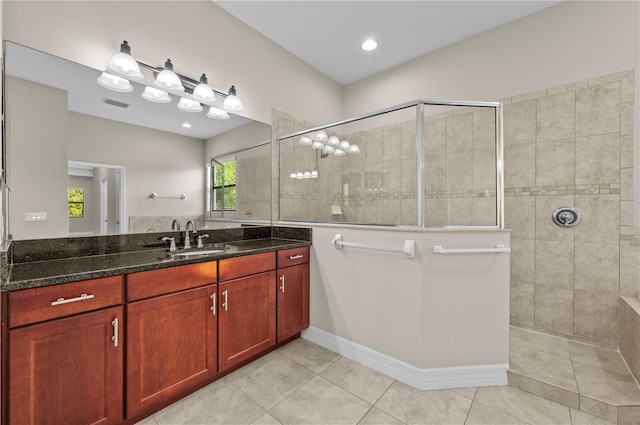 full bath featuring walk in shower, vanity, visible vents, and tile patterned flooring