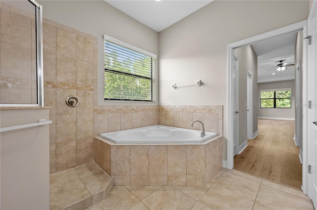 full bathroom featuring a garden tub, a ceiling fan, a walk in shower, and tile patterned floors