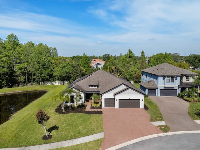view of front of house with a garage, a front lawn, and driveway