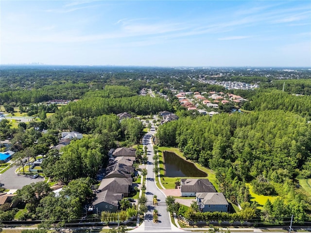birds eye view of property featuring a residential view, a water view, and a view of trees