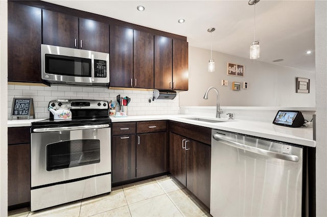 14910 Par Club Cir, Tampa, FL 33618 - kitchen featuring light tile patterned floors, a sink, light countertops, stainless steel appliances, and backsplash
