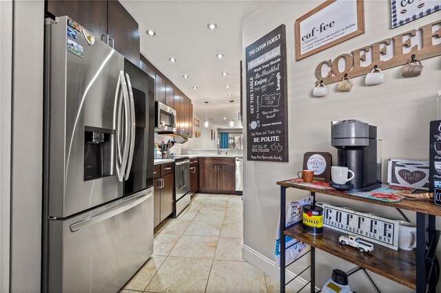 14910 Par Club Cir, Tampa, FL 33618 - kitchen with dark brown cabinets, recessed lighting, appliances with stainless steel finishes, light countertops, and baseboards