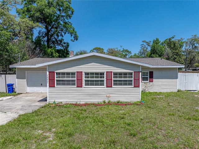 ranch-style house featuring an attached garage, driveway, fence, and a front lawn
