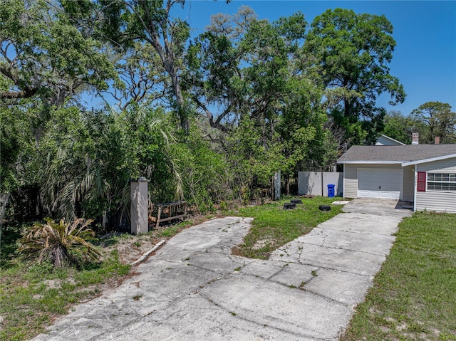 view of front of property featuring concrete driveway and a garage