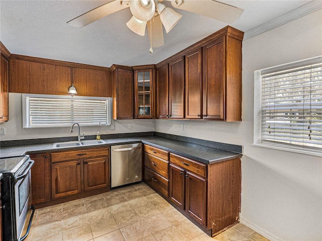 kitchen with glass insert cabinets, a sink, ceiling fan, appliances with stainless steel finishes, and dark countertops