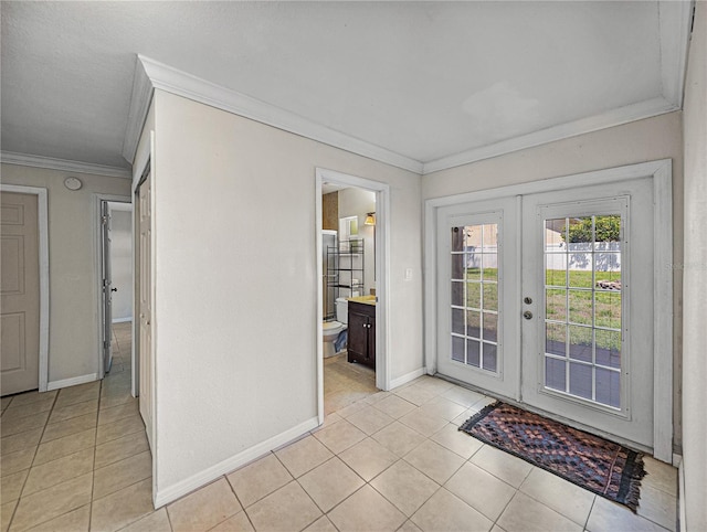 doorway to outside with crown molding, french doors, light tile patterned flooring, and baseboards