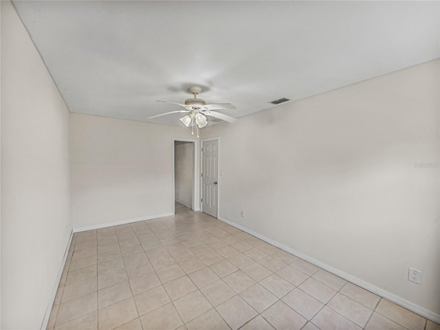 empty room featuring visible vents, baseboards, a ceiling fan, and light tile patterned flooring