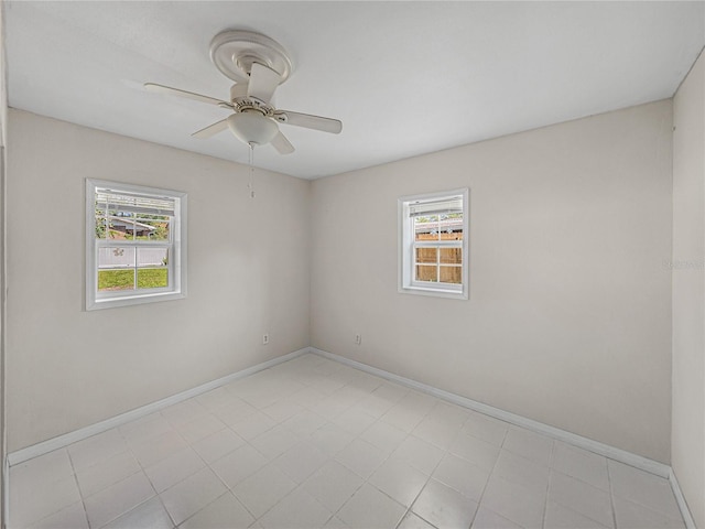 empty room with baseboards and a ceiling fan