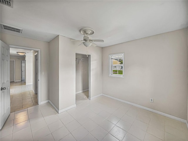 unfurnished bedroom featuring light tile patterned floors, visible vents, and a closet