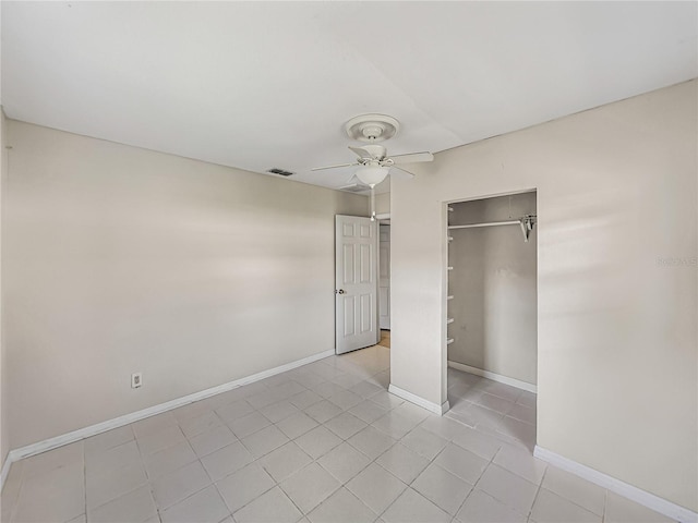 unfurnished bedroom featuring light tile patterned floors, visible vents, baseboards, and a ceiling fan