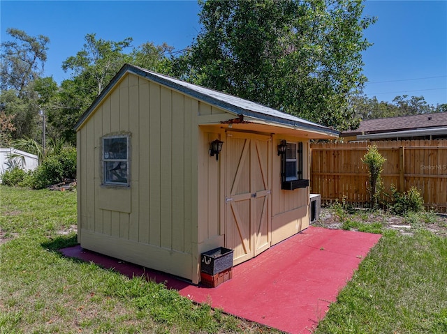 view of shed featuring fence