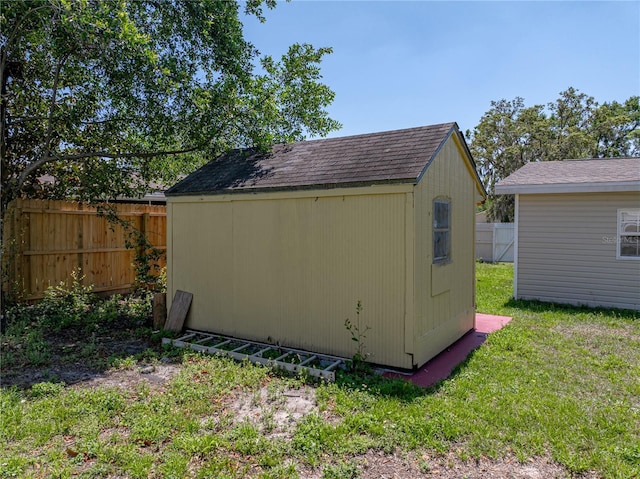 view of shed featuring fence