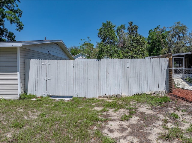 view of yard featuring fence and a gate