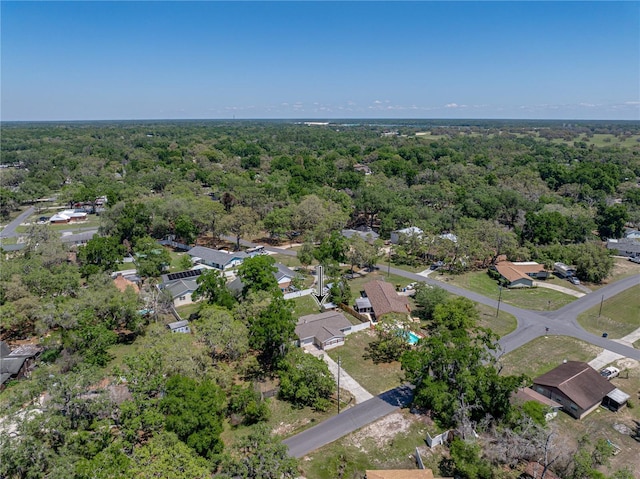 birds eye view of property with a forest view