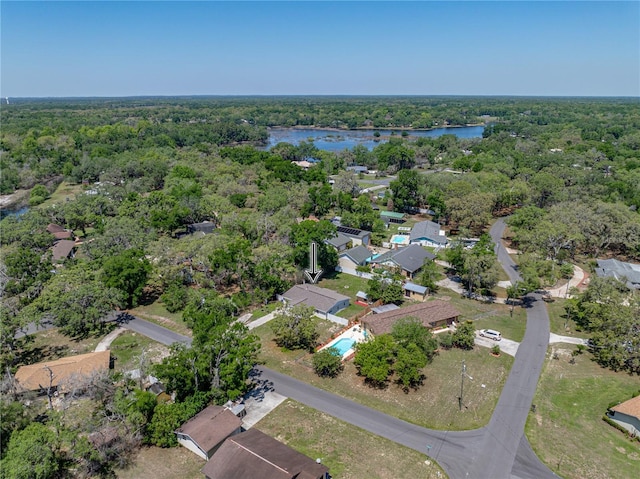 drone / aerial view featuring a water view and a forest view