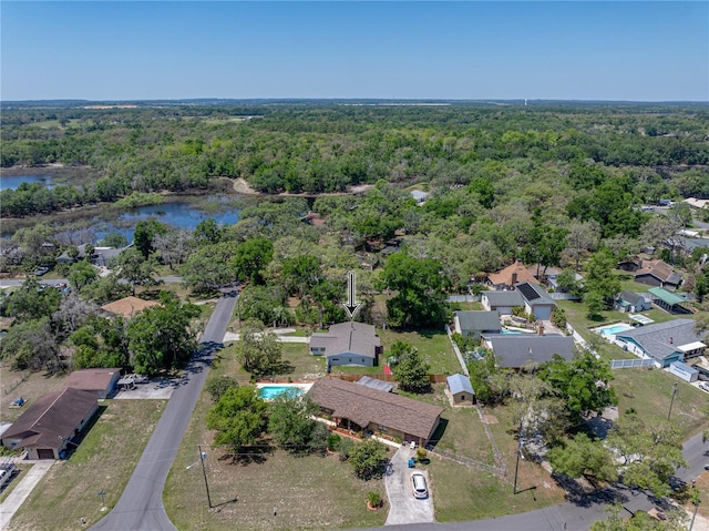 aerial view with a water view and a forest view