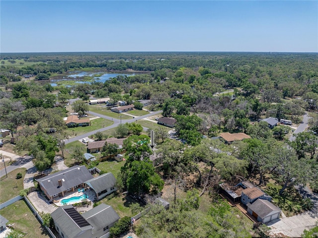 birds eye view of property with a water view and a forest view