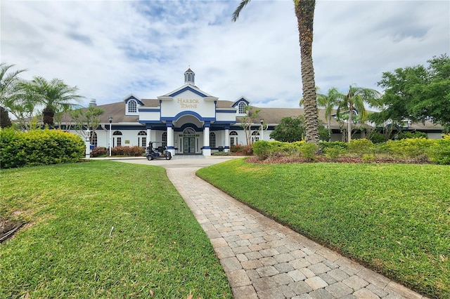 view of front of house with a front yard and stucco siding