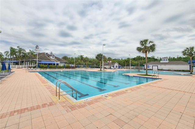 pool featuring a patio and fence