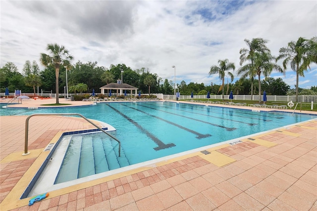community pool featuring a patio and fence