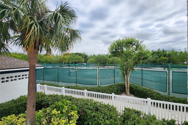 view of pool with a tennis court and fence