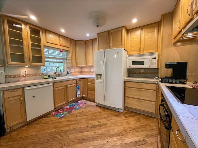 3647 Lake St, George Drive, Palm Harbor, FL 34684 - kitchen with black appliances, tile countertops, light wood-type flooring, glass insert cabinets, and recessed lighting
